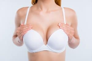 Woman with large, heavy breasts before a breast reduction and lift surgery